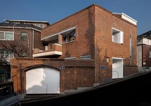 Seoul's 1970s House Reimagined: Red Brick and Zinc Sculpt a Wave-like Hybrid Studio-Home